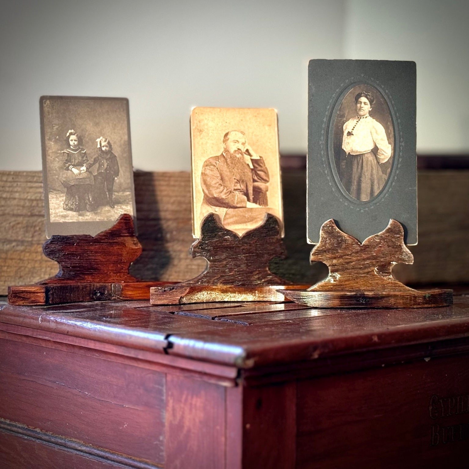 Found photograph pieces displayed in handmade reclaimed heart pine holders