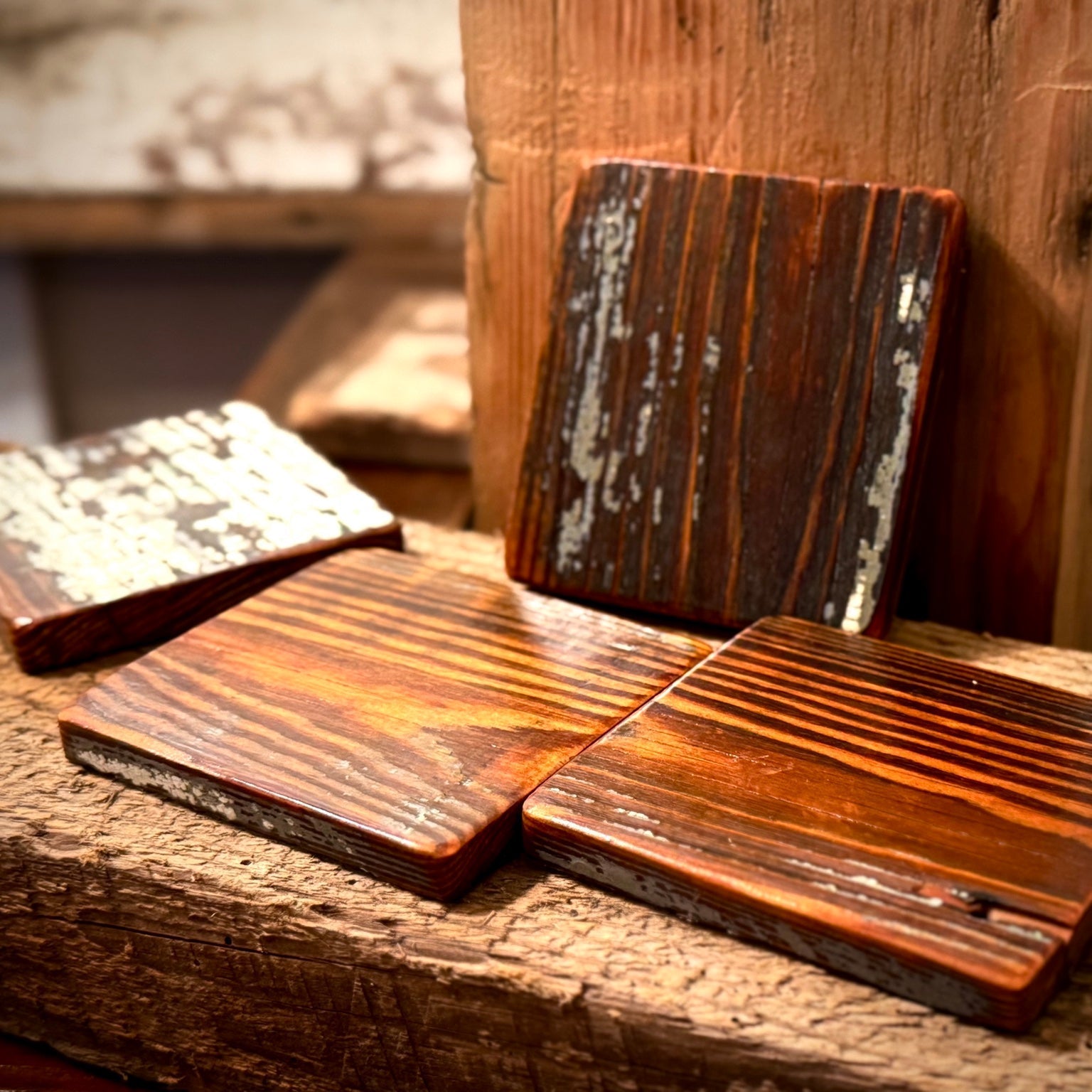 Detail photo of handmade reclaimed heart pine coasters showing unique grain and finish