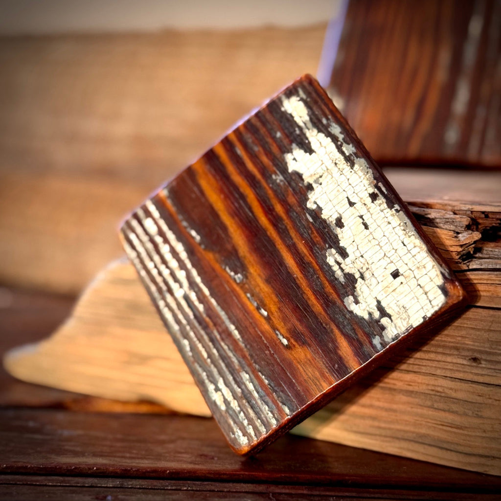 Single handmade heart pine coaster showing preserved old paint and reclaimed wood grain
